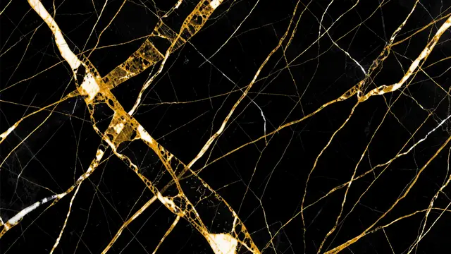 Glossy black marble surface with swirling interwoven gold and white veins