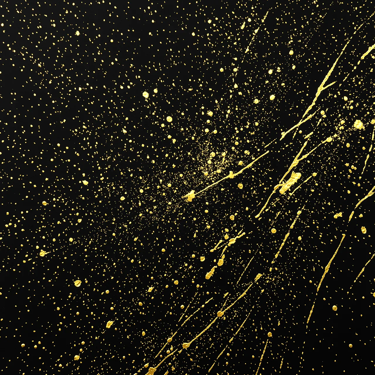 Metallic gold paint splatters and fine speckles scattered across a smooth matte black background