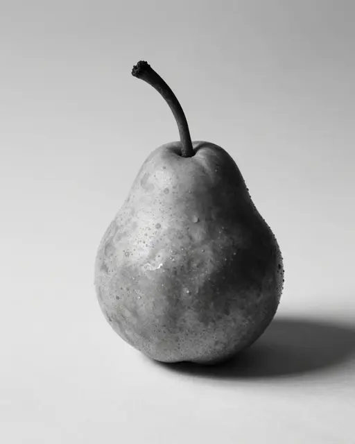 A single pear with a long curved stem and water droplets casts a soft shadow on a plain light background.