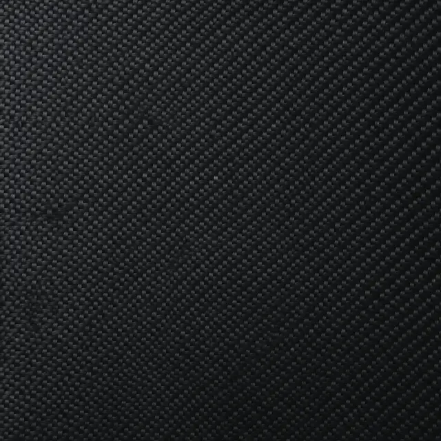 Full frame close-up of a fine diagonal twill weave glossy black carbon fiber surface