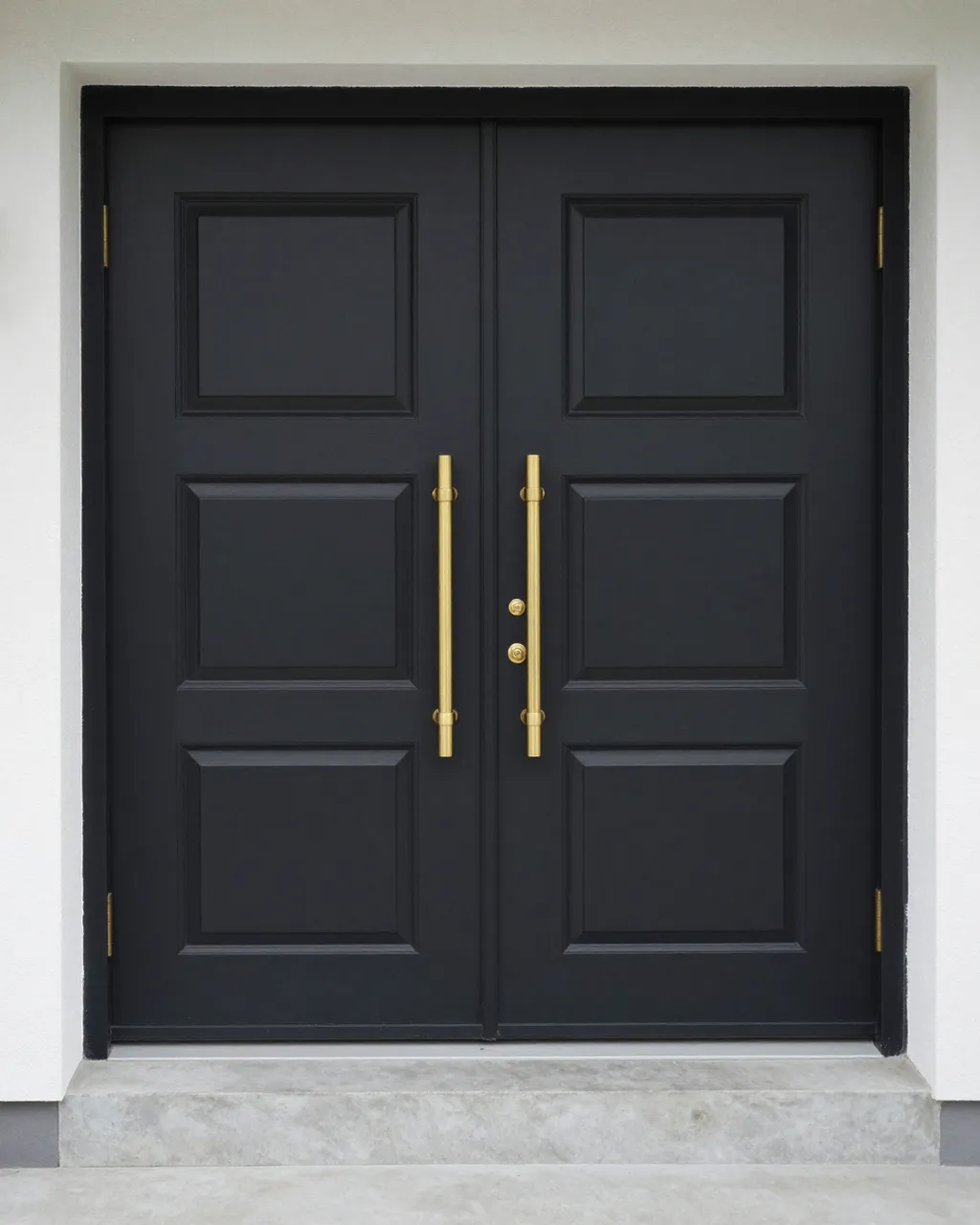 Modern black double front doors with long brass handles and a concrete entry step