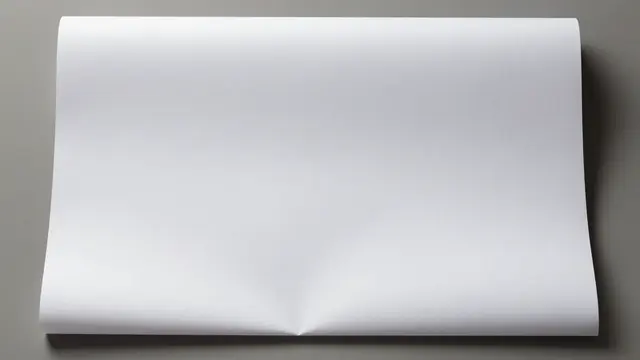 A curled blank white sheet of paper rests flat on a smooth gray surface