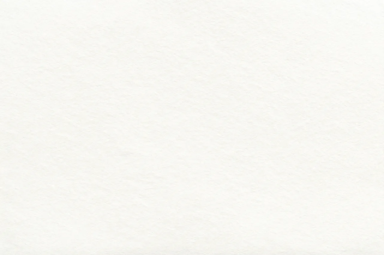 Subtle textured blank off-white watercolor paper fills the entire frame