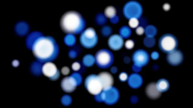 Soft blurred blue and white bokeh orbs of varying sizes float on a solid pure black background