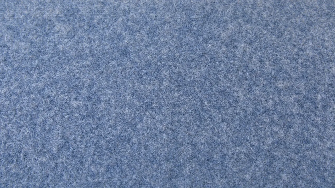 Full frame close-up of soft blue-grey wool felt showing fine matted fiber texture