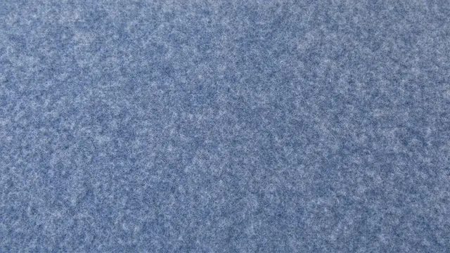 Full frame close-up of soft blue-grey wool felt showing fine matted fiber texture