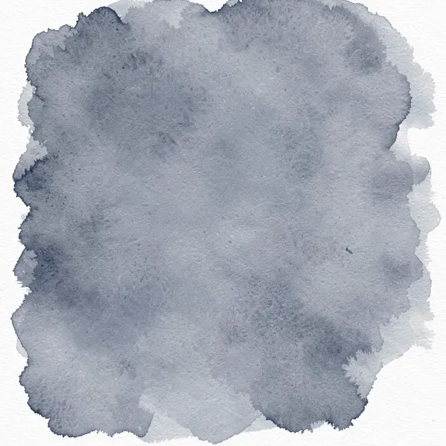 A soft blue-grey watercolor splotch with darker pooled edges sits on textured white paper