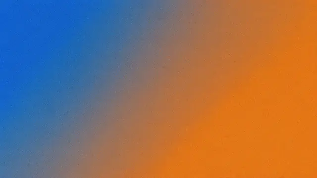 A smooth duotone diagonal gradient from deep blue to warm orange with fine heavy grain texture