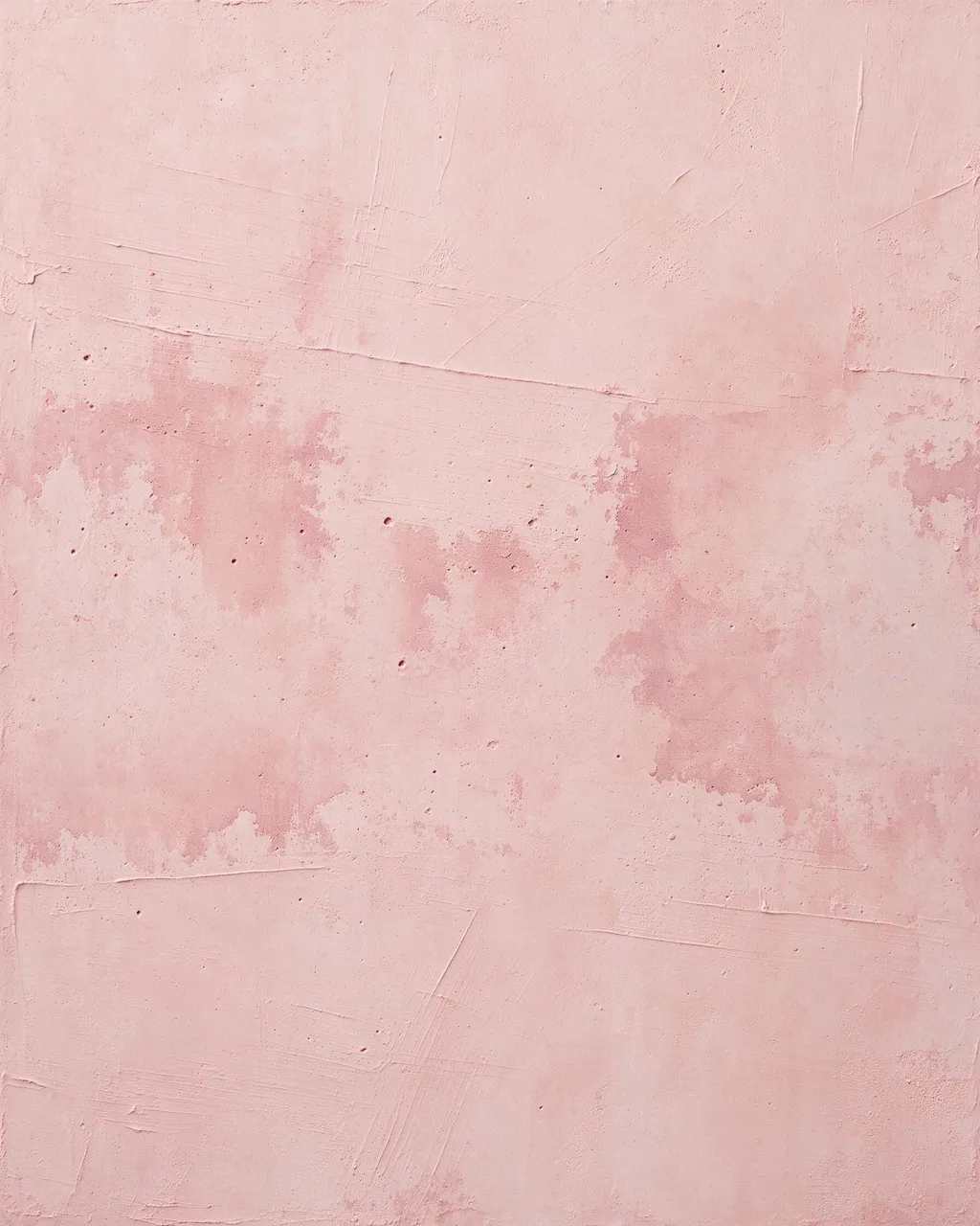 Full frame close-up of blush pink skim coat plaster with visible trowel sweeps and darker drying patches under flat lighting