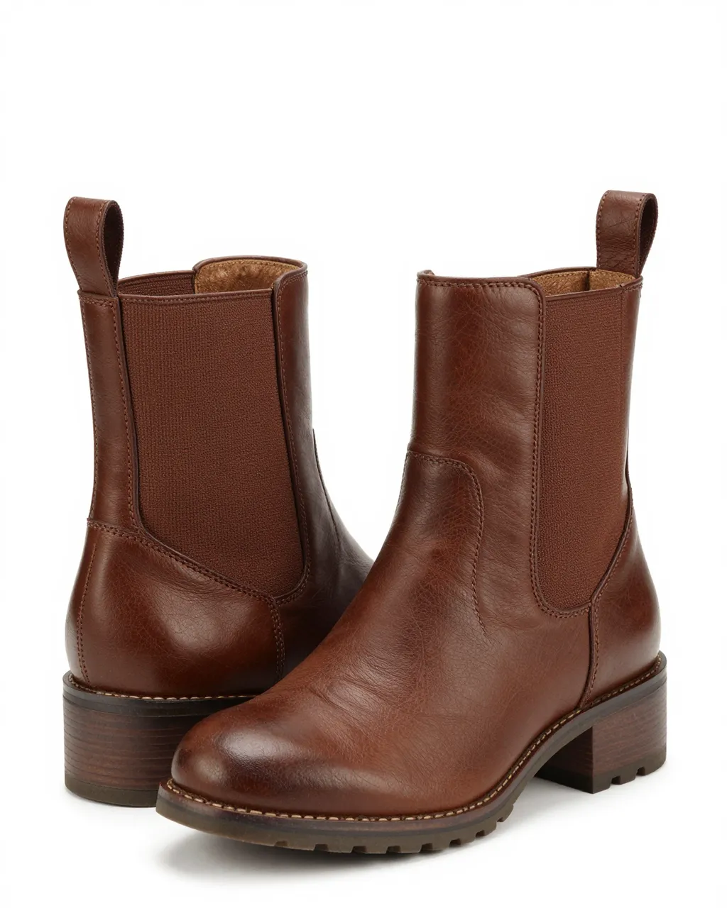 Pair of brown leather elastic-side ankle boots arranged on a plain white studio background
