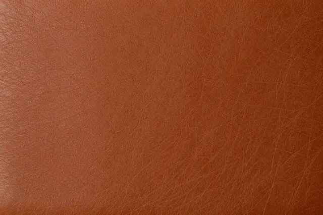 Full frame close-up view of warm brown leather with natural fine grain texture