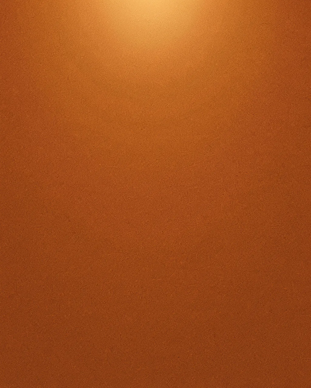 A full frame burnt orange grainy background with a soft warm glow at the top and empty copy space