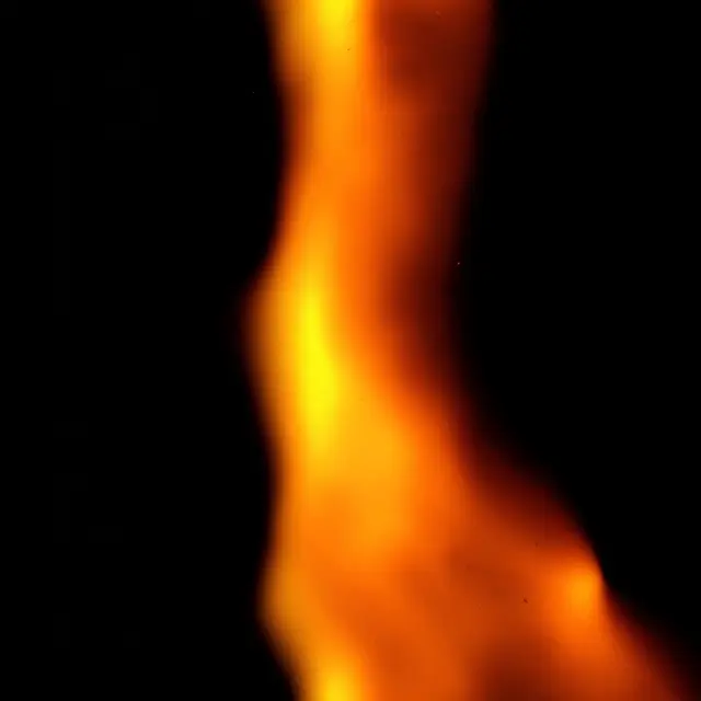A soft burnt orange light leak with bright yellow highlights sits on a pure black background