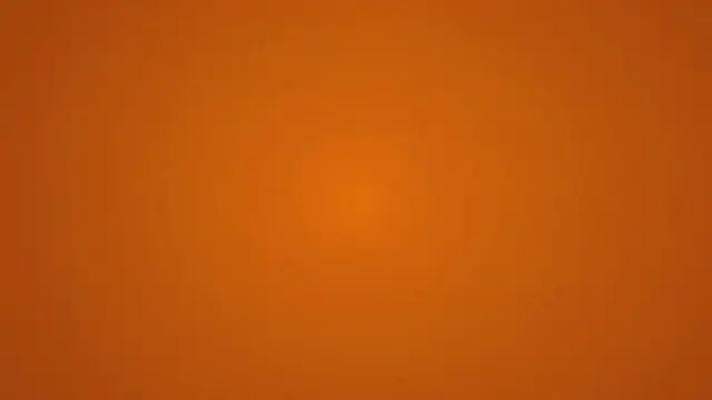 A full frame burnt orange background with soft grain and a subtle central warm glow