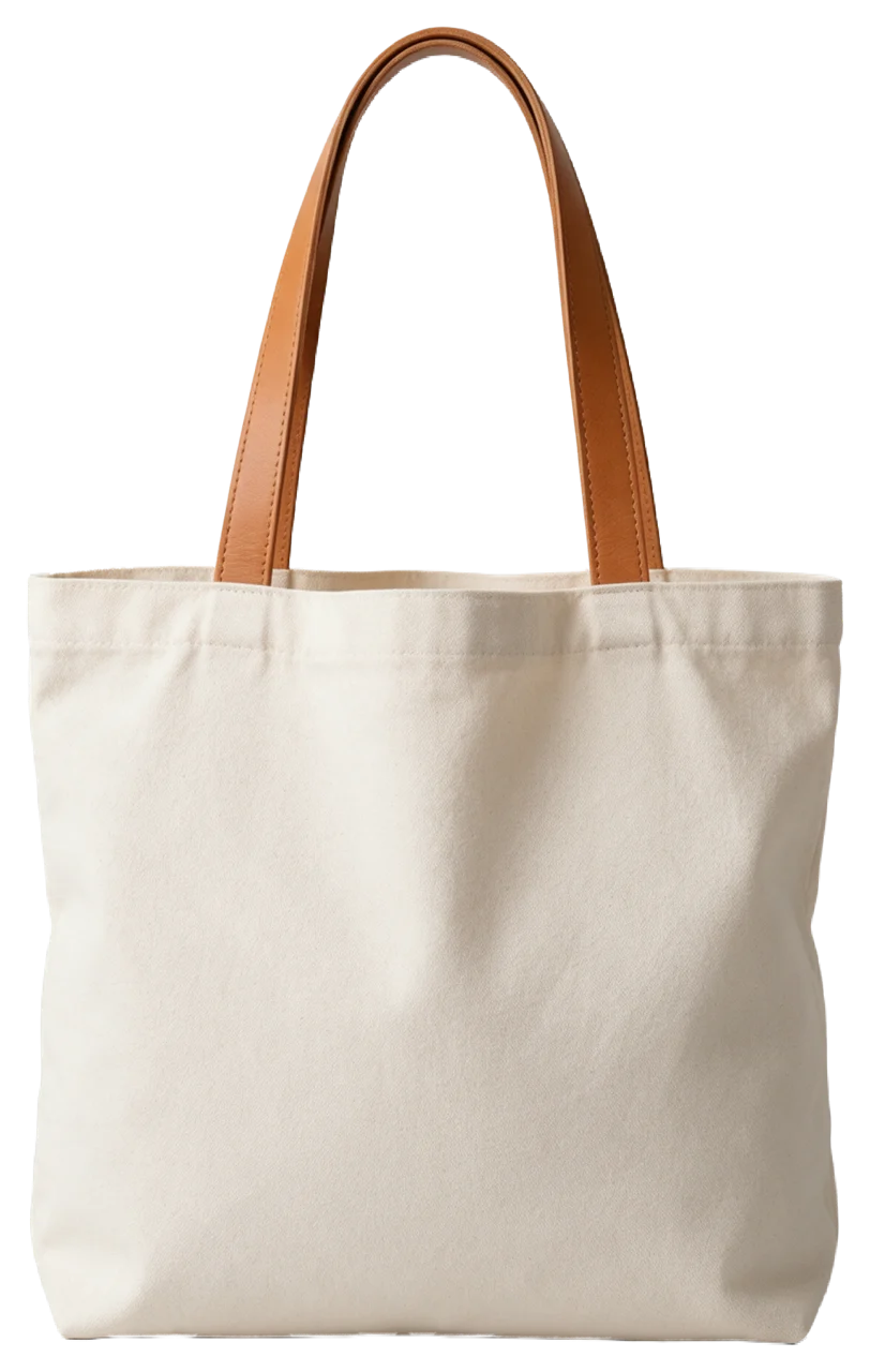 Plain natural canvas tote bag with tan leather handles, softly filled and unprinted