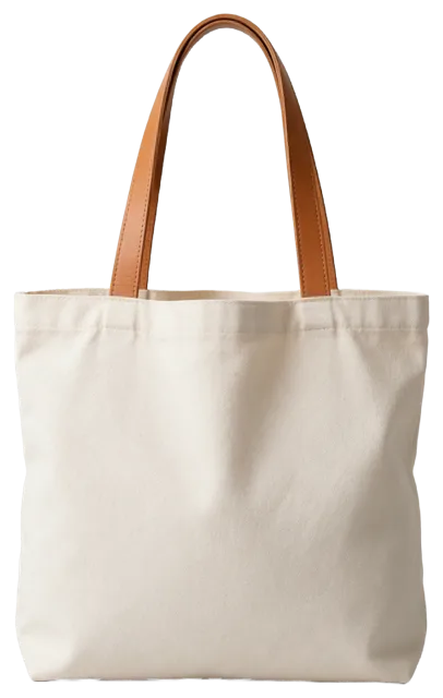 Plain natural canvas tote bag with tan leather handles, softly filled and unprinted