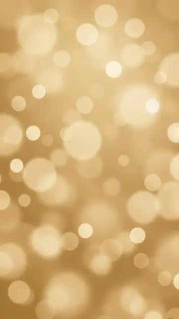 Soft circular pale bokeh lights scattered across a warm champagne gold vertical background