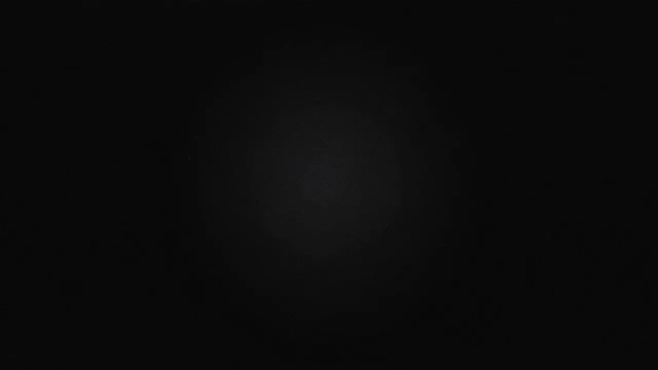 Dark charcoal textured background with a faint soft glow in the center