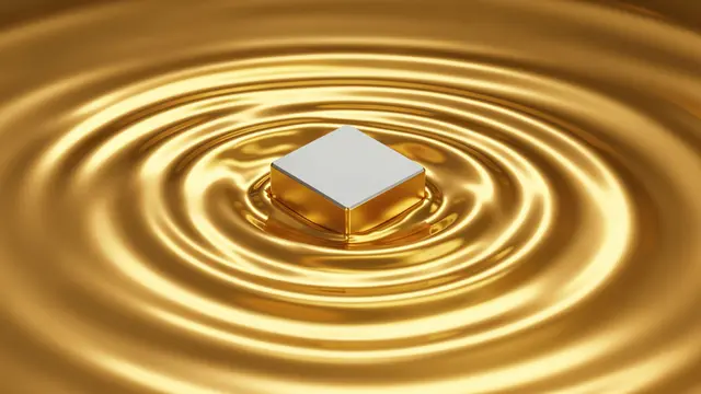 A blank square semiconductor chip rests in rippling glossy liquid gold with concentric glowing waves spreading outward.