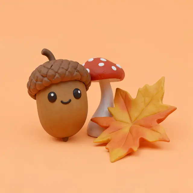 Cute clay 3D render of a smiling acorn, spotted toadstool, and maple leaf on a pastel orange background