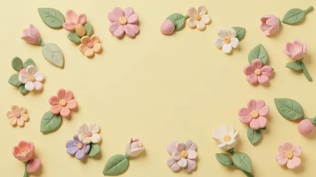 Handmade 3D clay flowers and leaves form a decorative border around a blank pastel yellow background