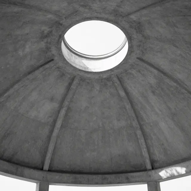 Low angle black and white view looking up at a textured concrete pavilion dome with a central round skylight