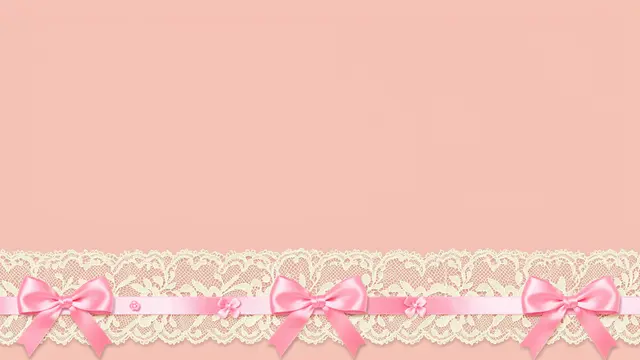 Blush pink desktop wallpaper with cream lace trim and pink satin bows along the bottom edge