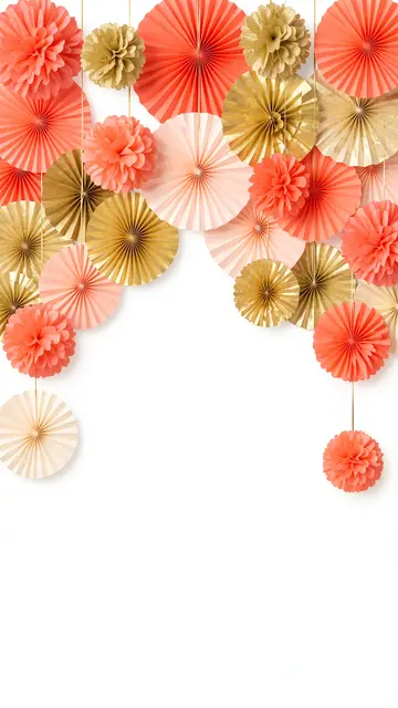 Hanging coral, peach and gold tissue fans and pom-poms form an arch against empty white copy space.