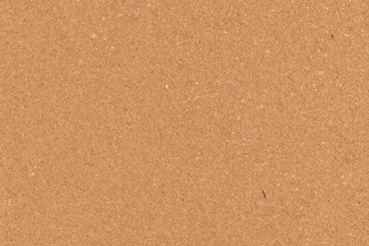 Seamless warm tan textured cork board surface filling the entire frame