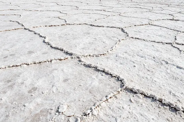 Close-up full frame of cracked textured white salt crust from a dry salt flat