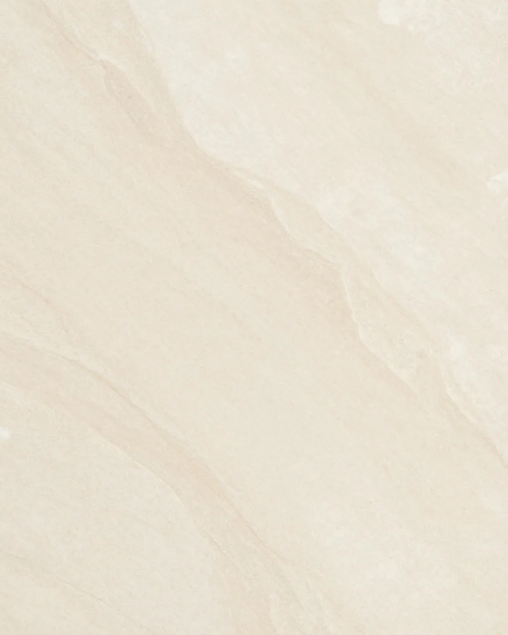 Full frame close-up of a smooth honed beige marble surface with soft tan veining and even lighting