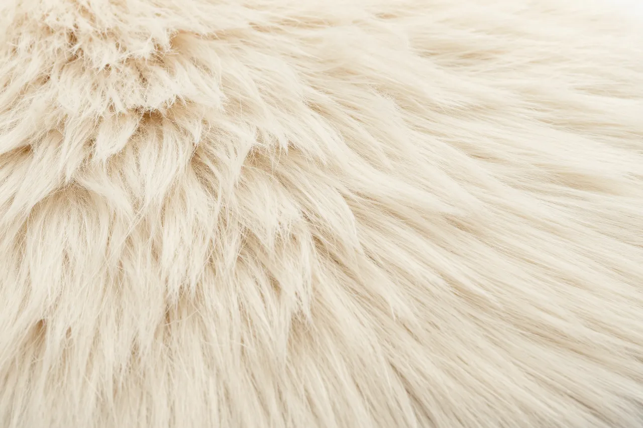 Close-up full frame view of soft textured cream colored faux fur