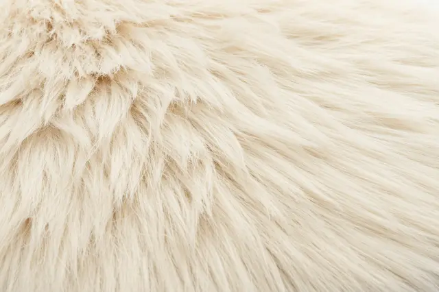 Close-up full frame view of soft textured cream colored faux fur