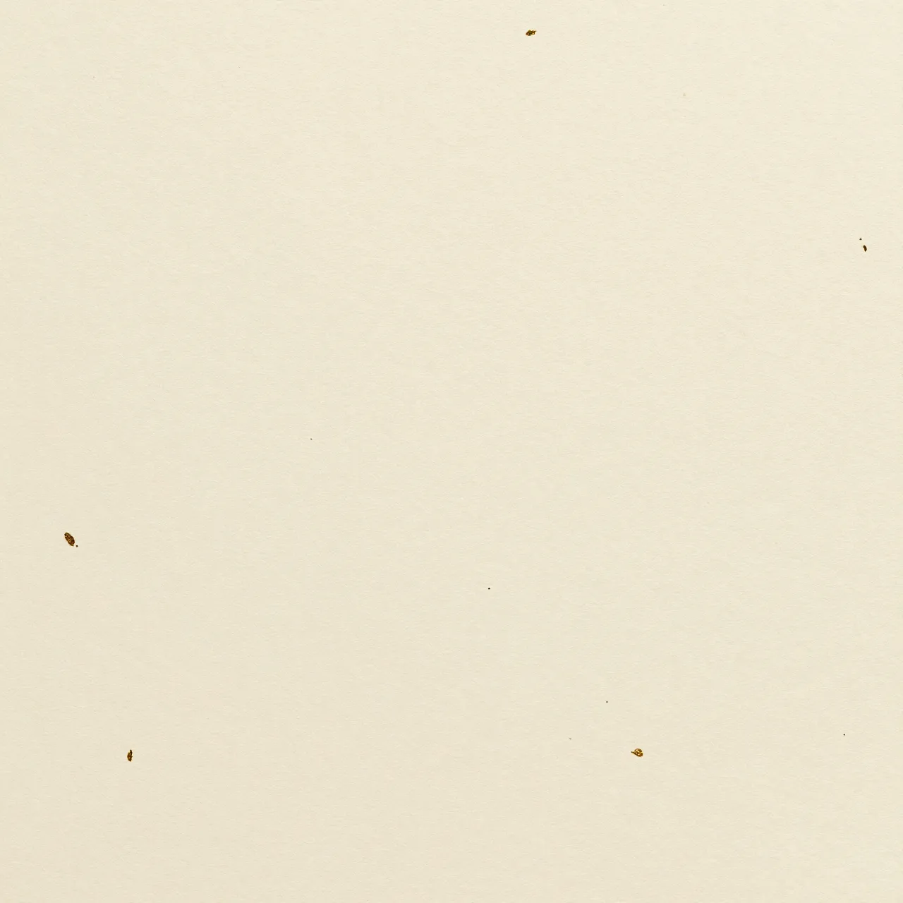 Full frame view of smooth cream handmade paper scattered with tiny gold leaf flecks under even light
