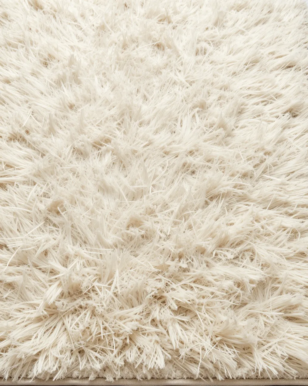 Close-up top view of soft long-pile cream shag rug under even lighting