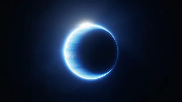 A thin glowing crescent of a blue gas giant is lit by distant starlight against dark deep space