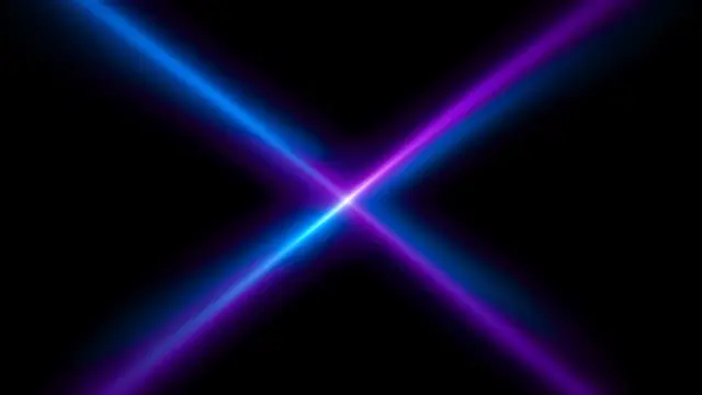 Crossing glowing blue and violet stage light beams converge at a bright central point against pure black