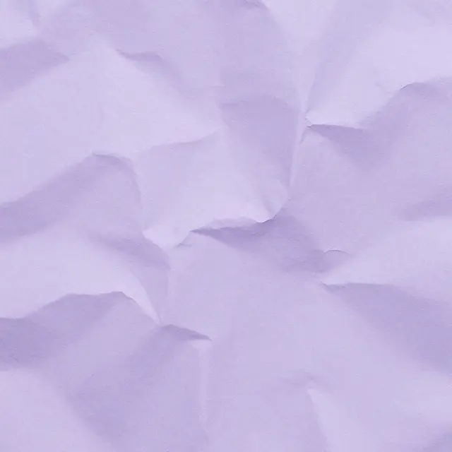 Full frame close-up of crumpled soft lavender paper with fine wrinkled folds and subtle shadows