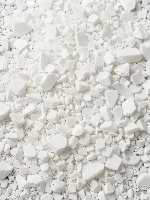 Top view close-up of densely packed crushed white marble chips filling the entire frame