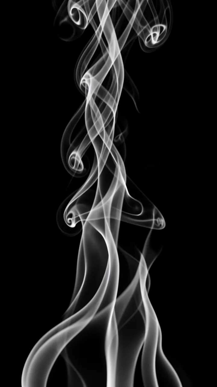 Soft twisting white smoke wisps curl upward against a solid pure black background