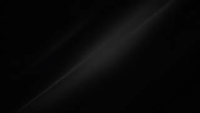 Subtle soft diagonal light streaks stretch across a deep near-black background
