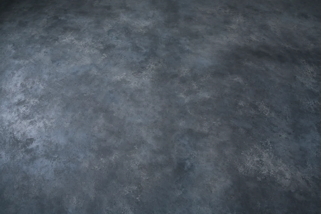 Full frame top view of a continuous low-sheen dark gray microcement surface with soft tonal shifts
