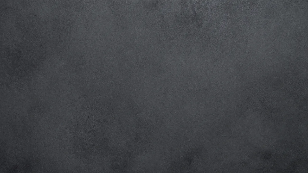 Seamless muted dark gray grunge concrete texture fills the entire frame