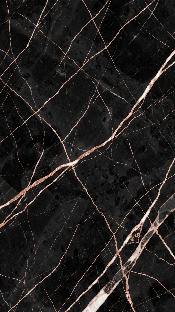 Polished black marble surface with thin rose gold and pale white veining