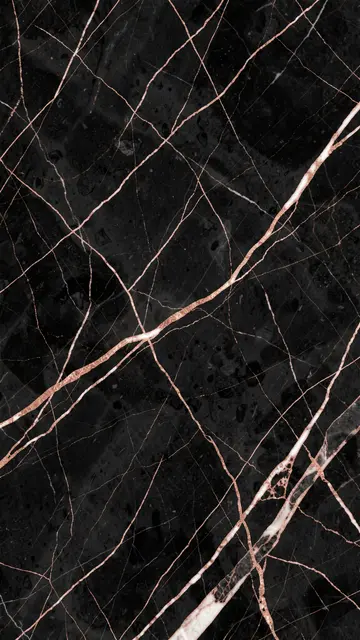 Polished black marble surface with thin rose gold and pale white veining