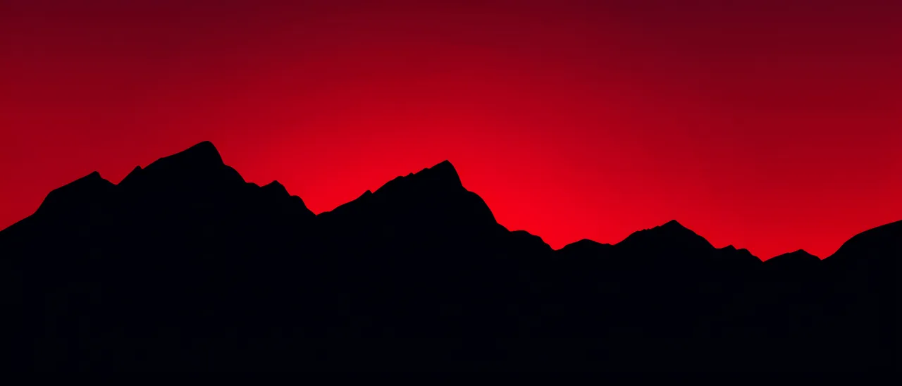 Black mountain ridge silhouette against a smooth deep red gradient sunset sky