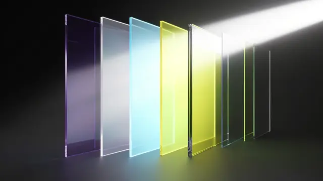 A beam of white light passes through a row of translucent colored glass panels against a dark background