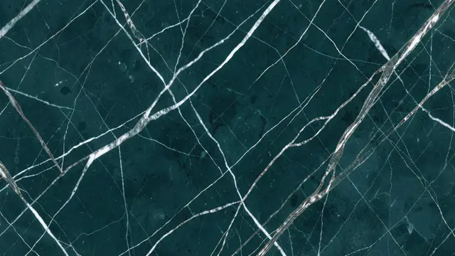 Full frame close up of deep teal marble with delicate white and metallic silver veins