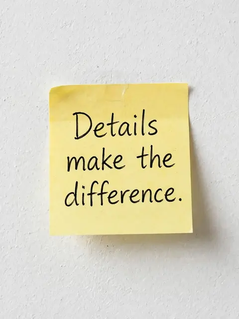 A yellow sticky note stuck to a textured white wall displays the handwritten quote "Details make the difference."