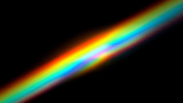 A smooth diagonal rainbow prism light streak extends across a solid pure black background